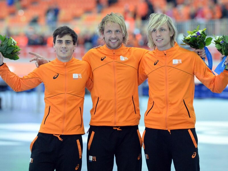 Three Athletes on Podium — Orange