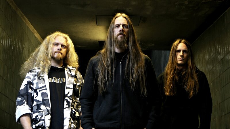 three band members in a hallway