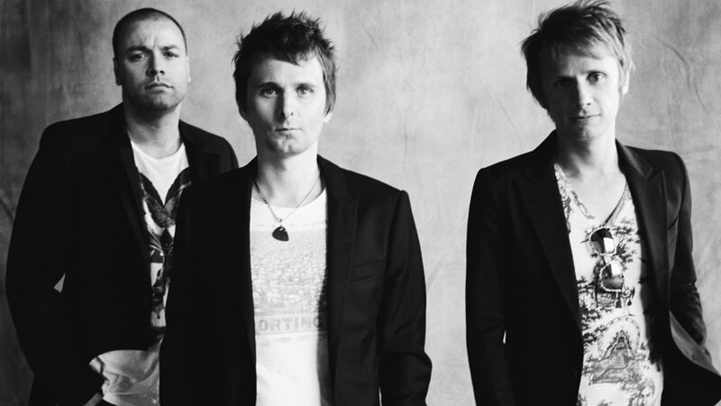 three band members in black and white