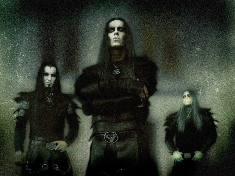 three band members in dark attire