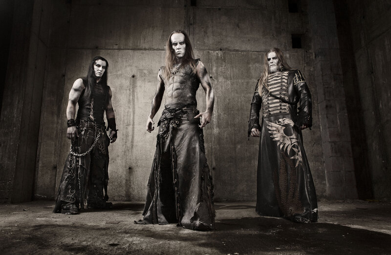 Three band members in dark attire