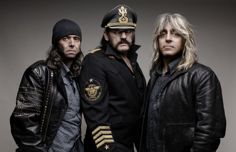 Three band members in military-style attire