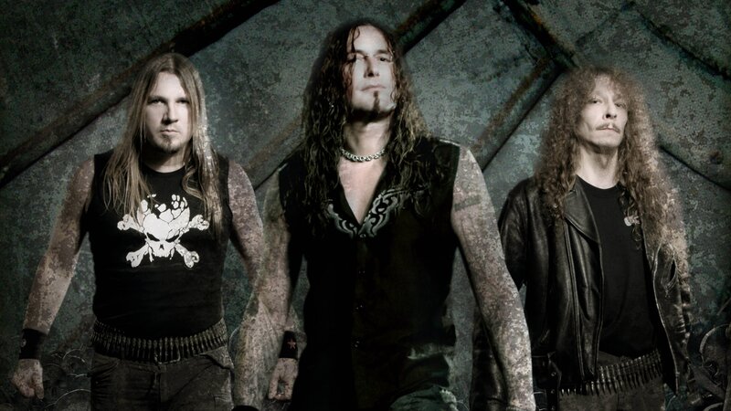 three band members in rock attire