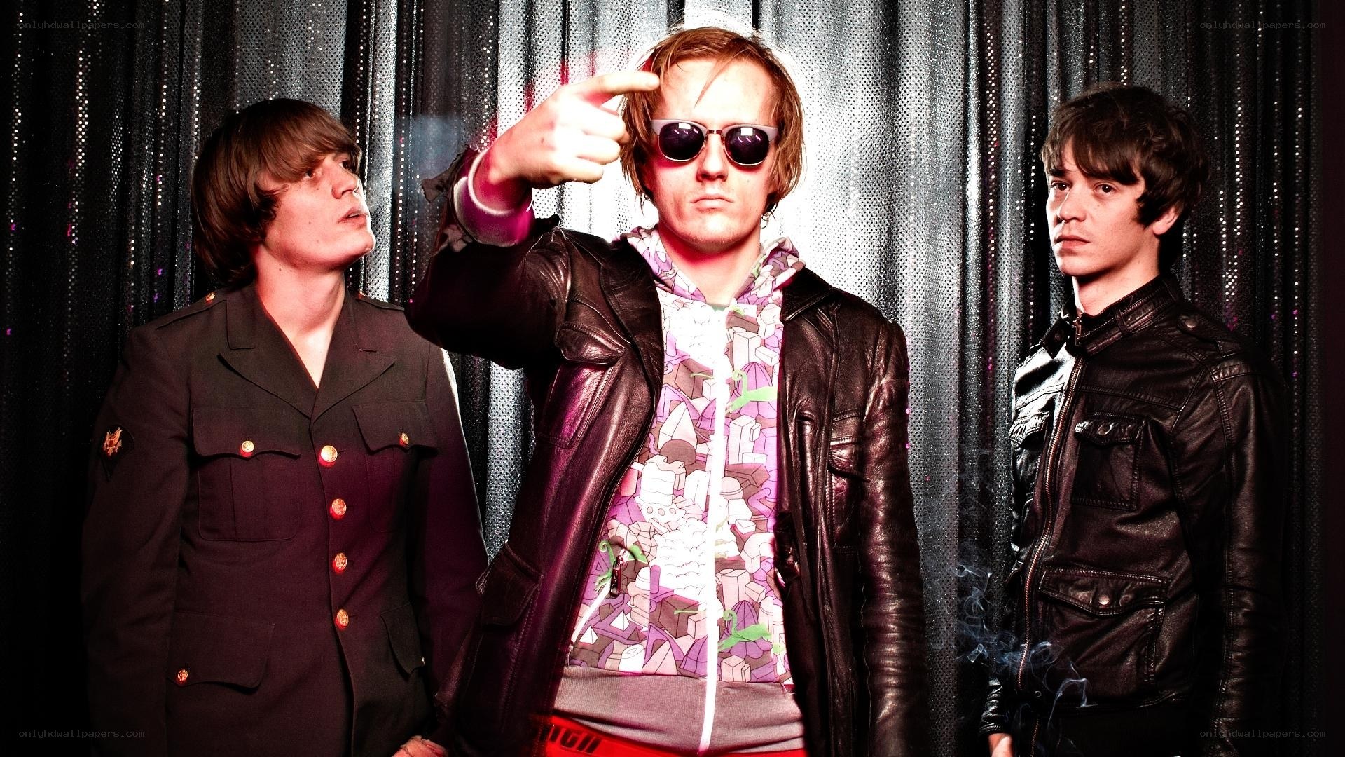 three band members posing
