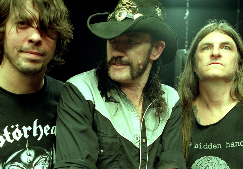 three band members posing