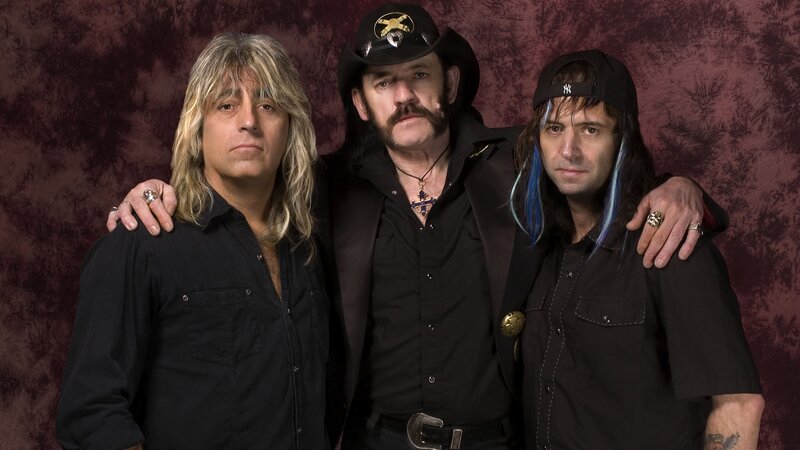 three band members posing together