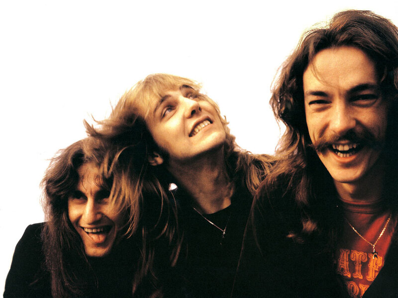 three band members smiling