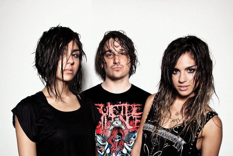 three band members with wet hair