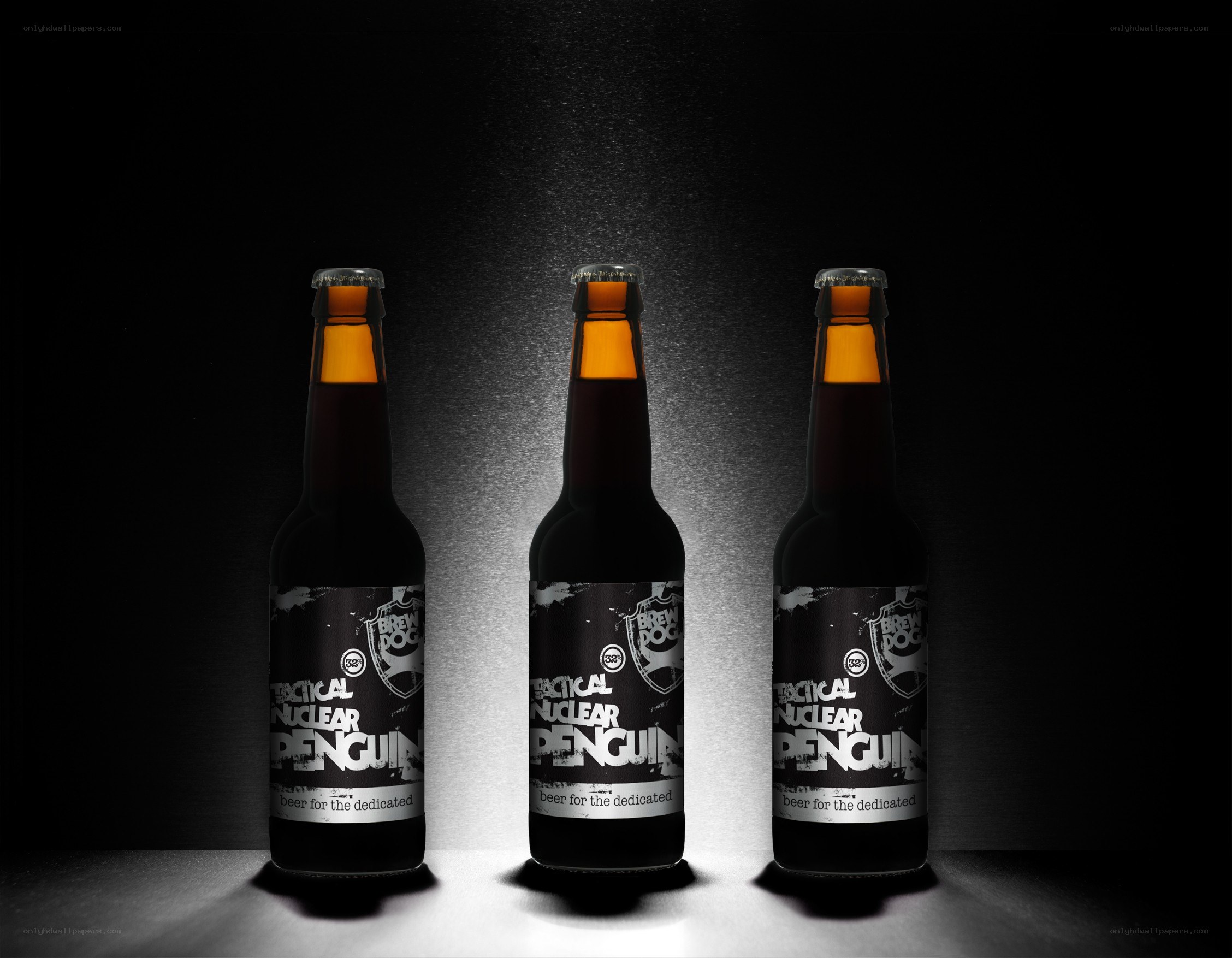 three beer bottles in spotlight
