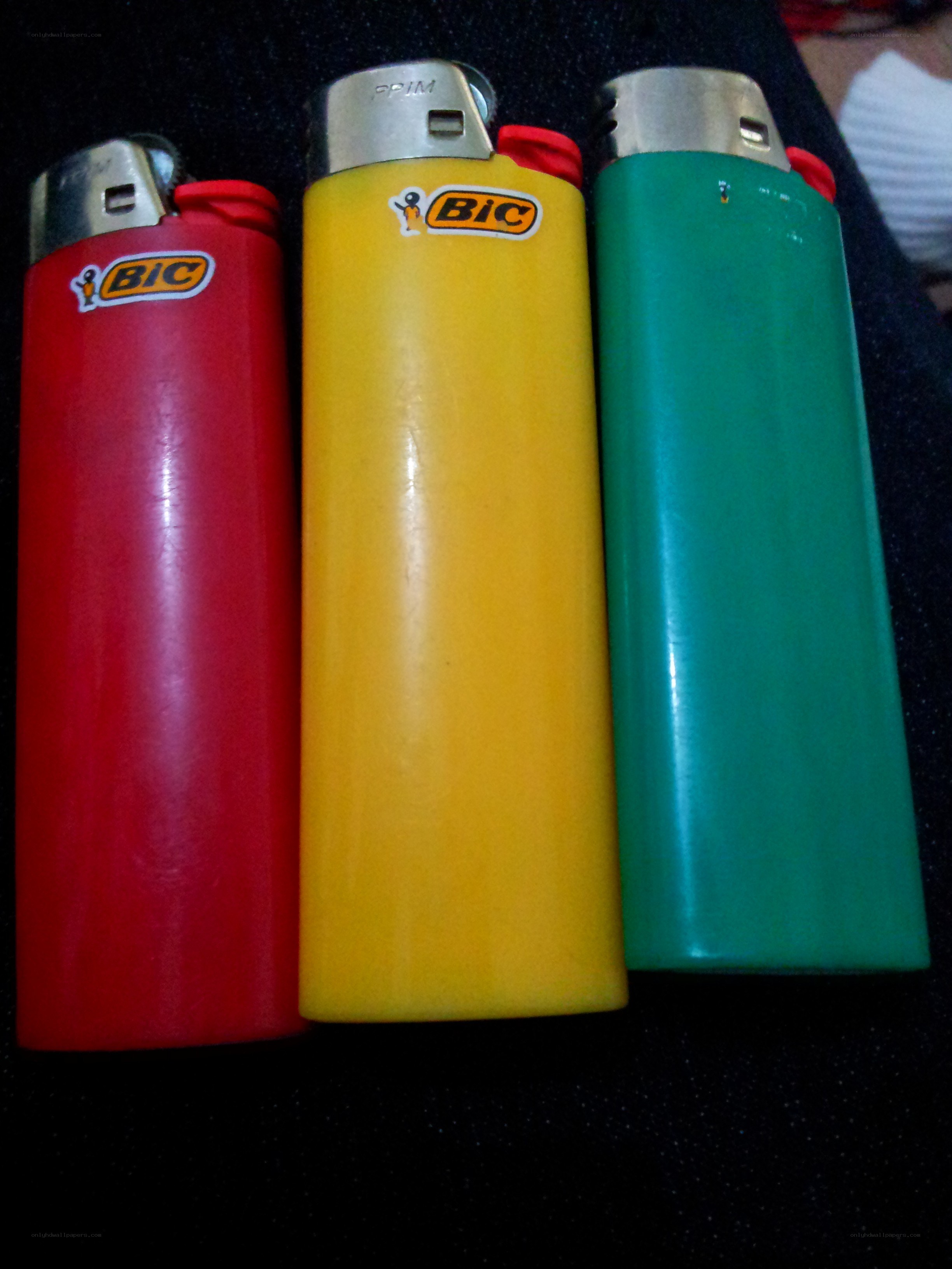 Three BIC lighters in red yellow green