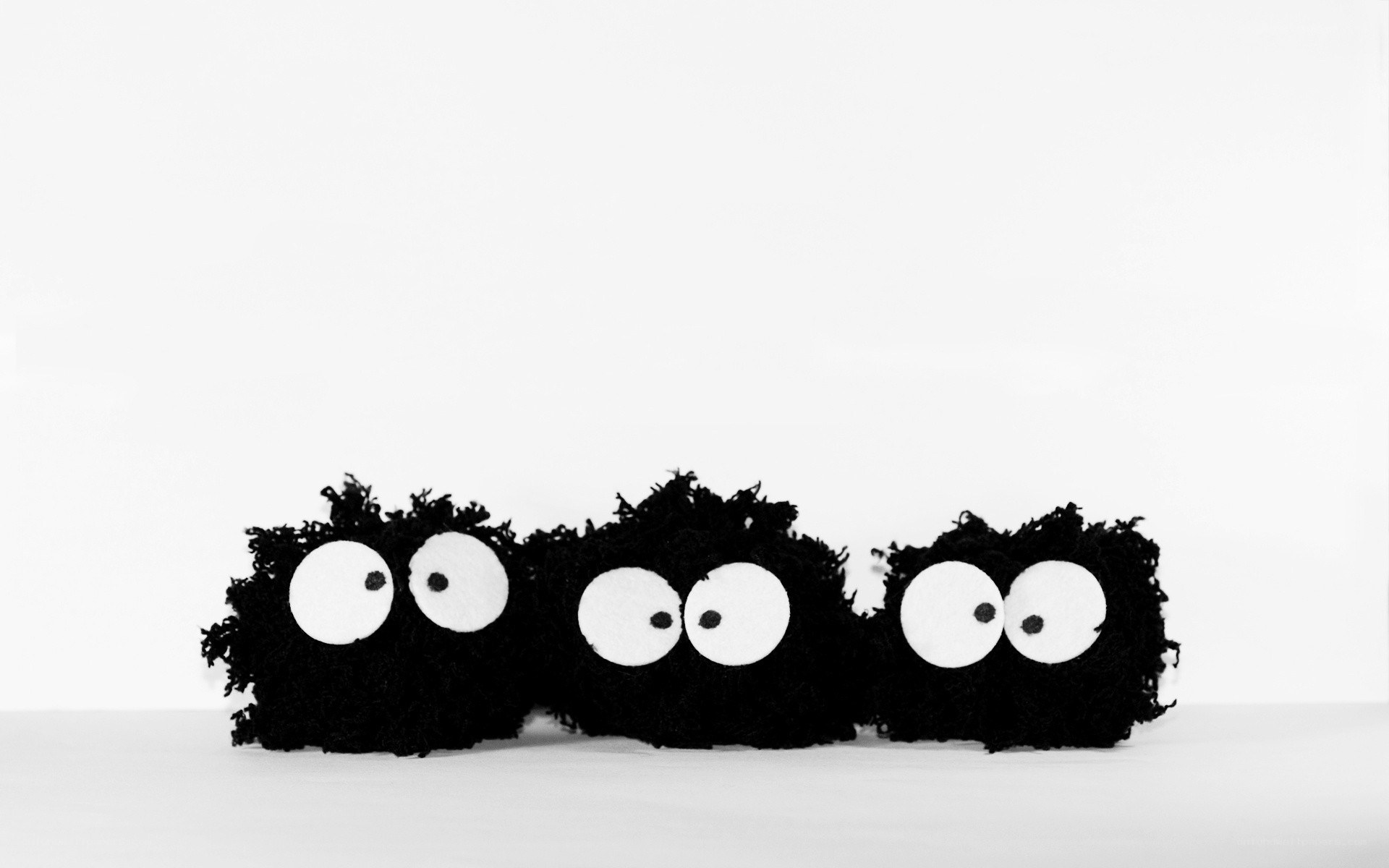 three black creatures with big eyes