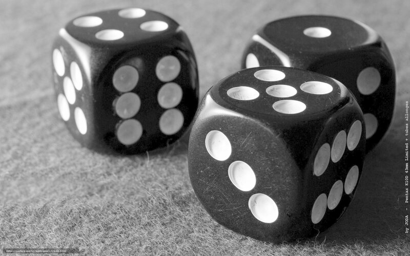 Three black dice on a surface