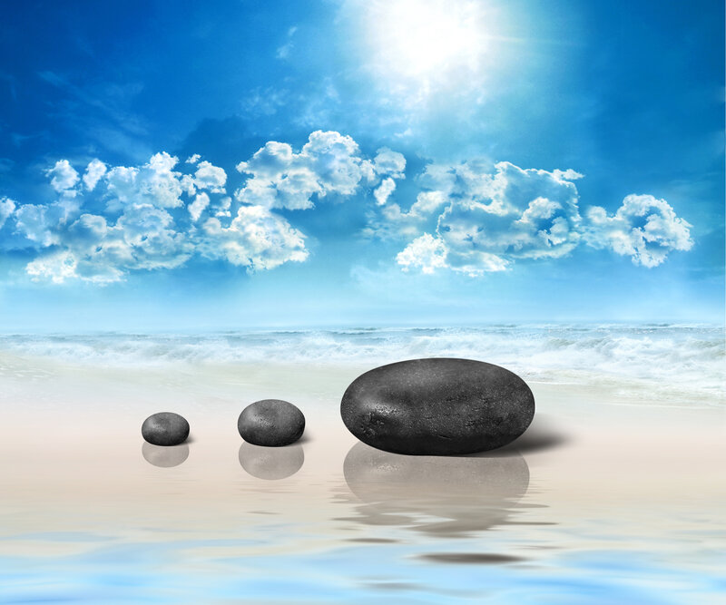 Three Black Stones on Beach