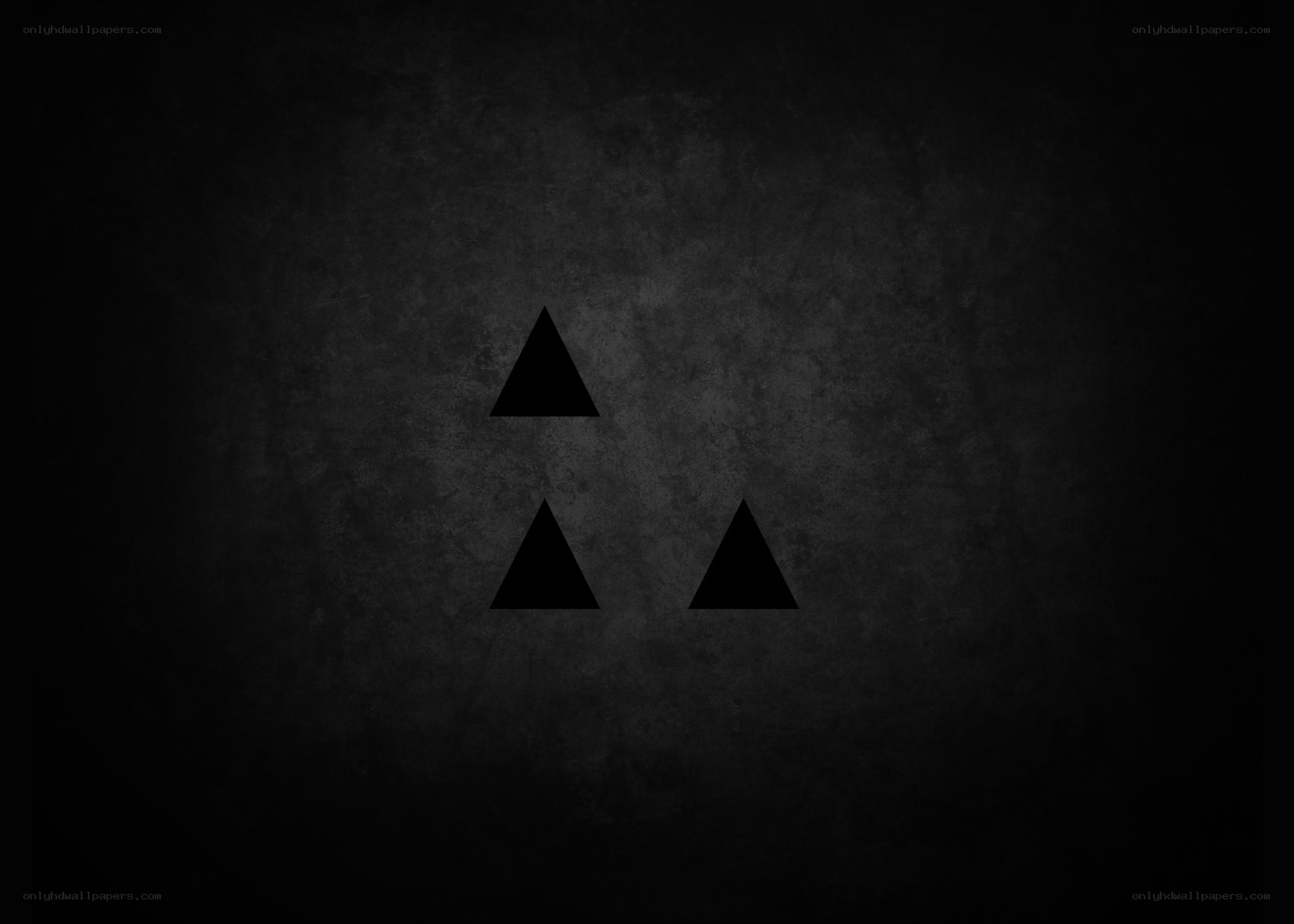three black triangles on dark background