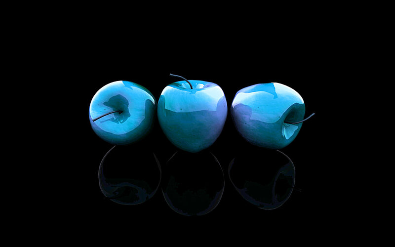 Three blue apples on black