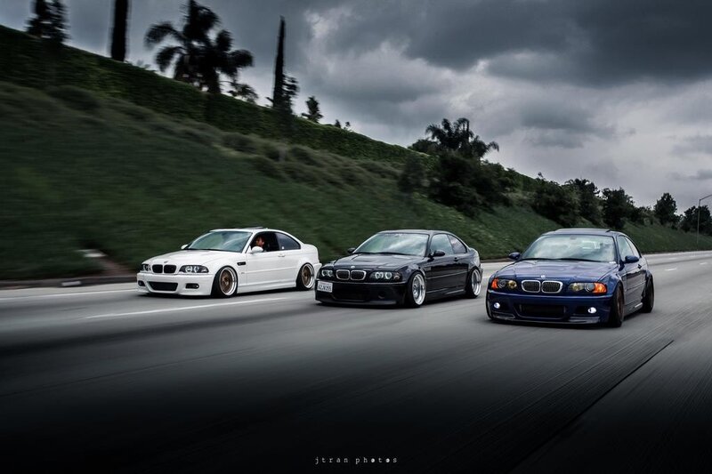 Three BMW cars on a road