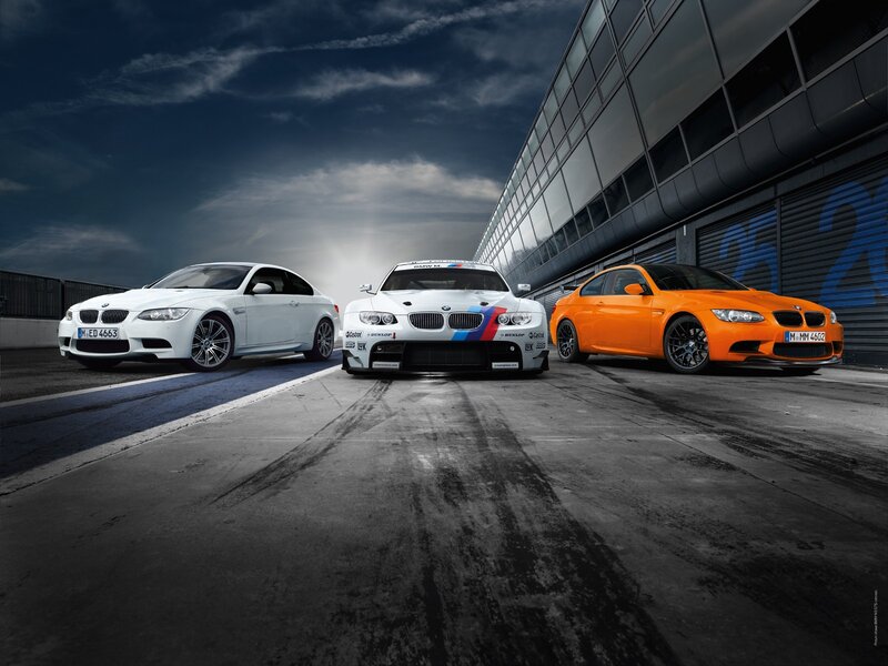 Three BMW M3 cars on a racetrack
