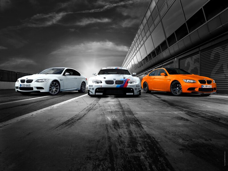 Three BMW M3 cars on a racetrack