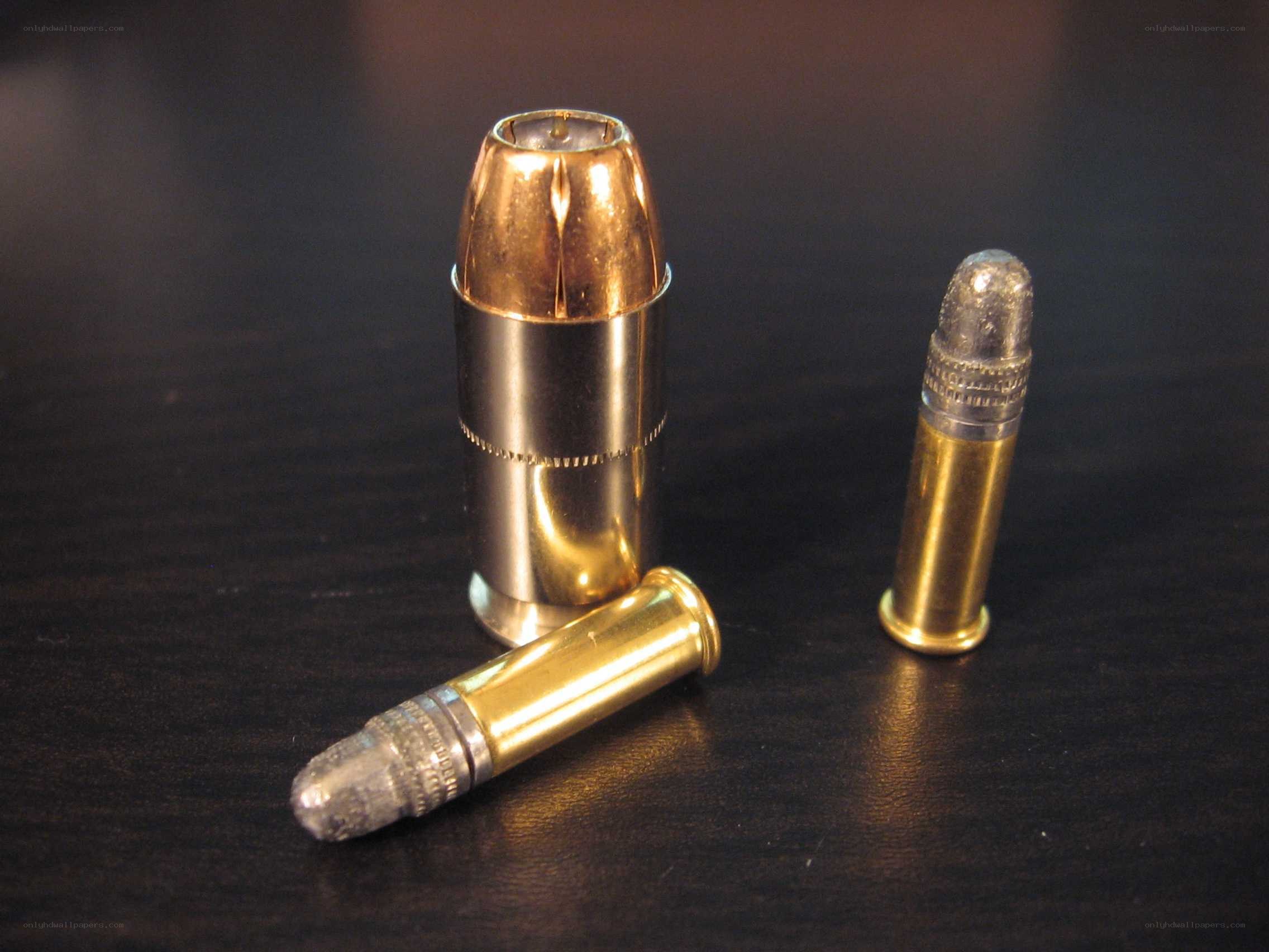 Three bullets on a dark surface