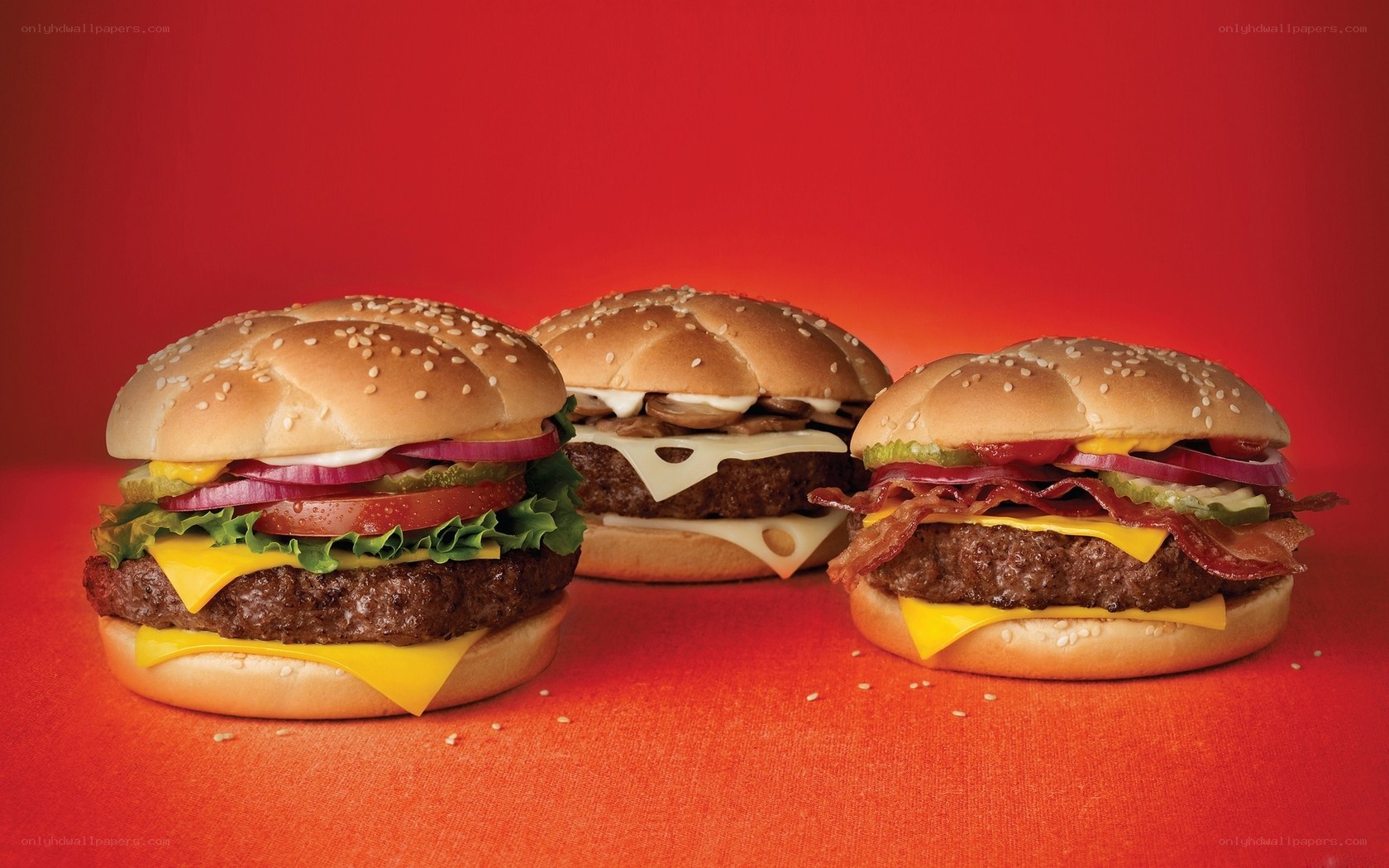 Three burgers on red background