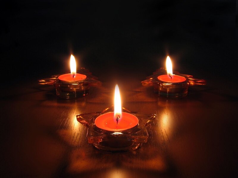 Three candles in star holders