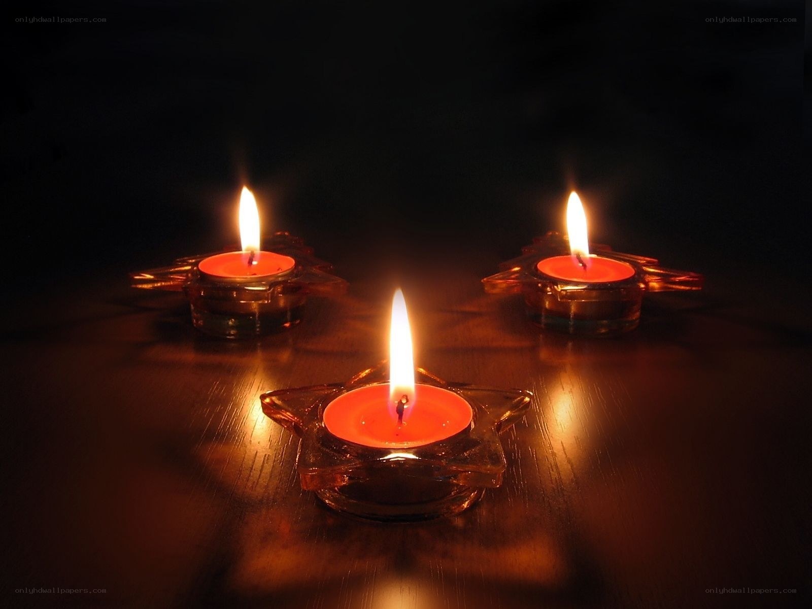 Three candles in star holders