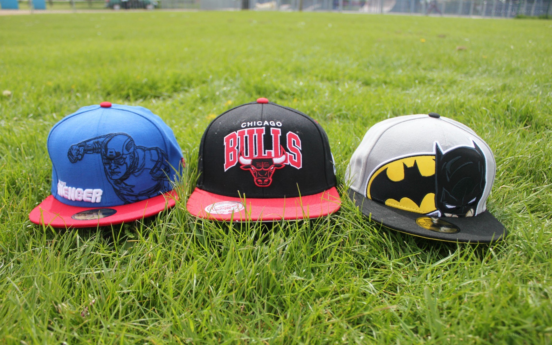three caps on grass
