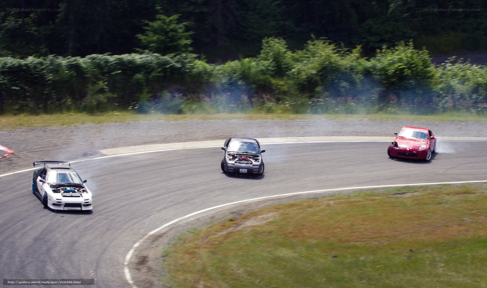 Three cars drifting on a track