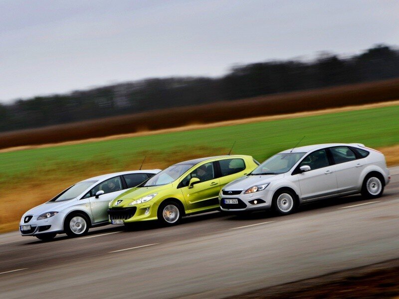 Three cars driving on a road