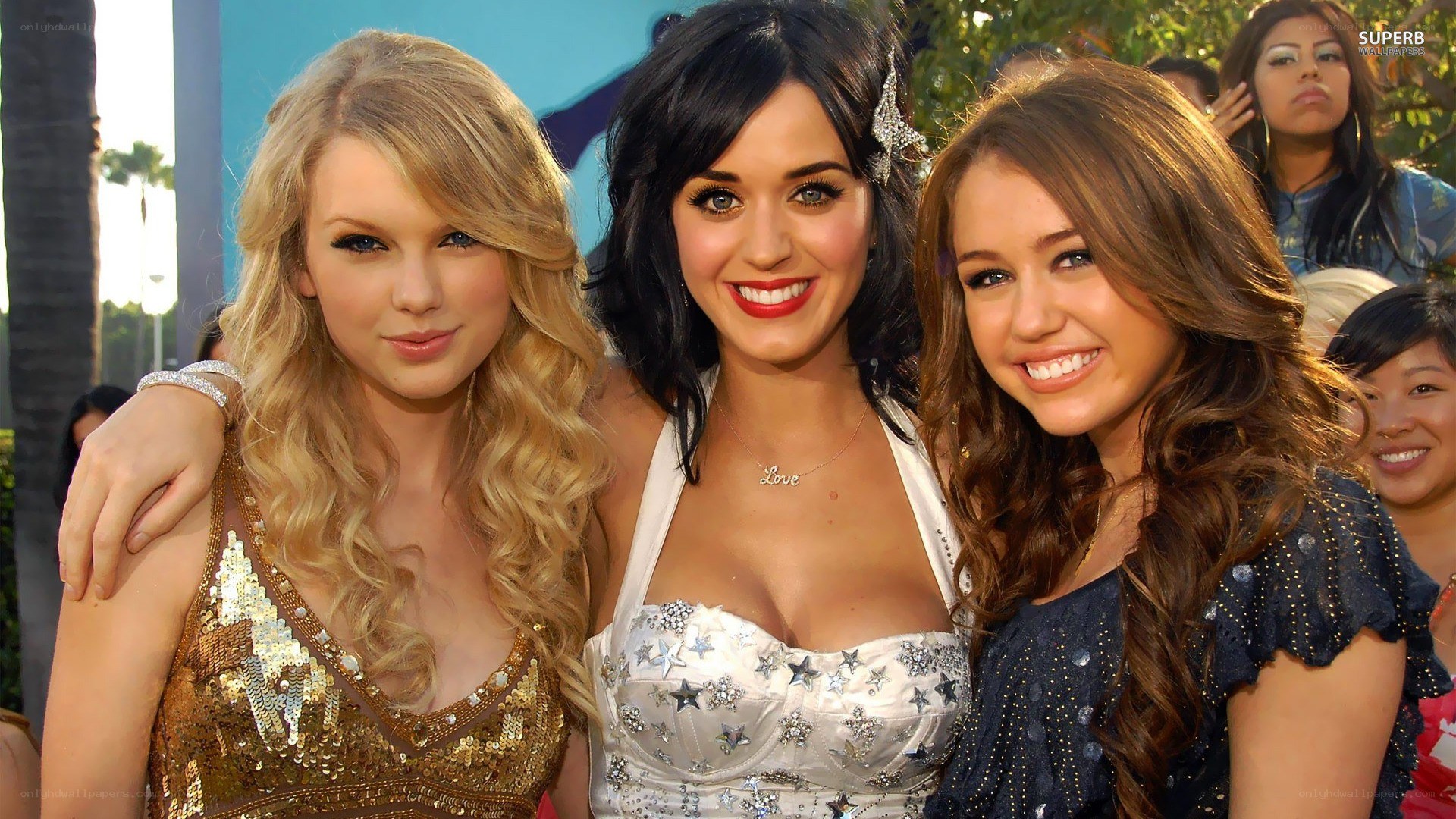 three celebrities at an event