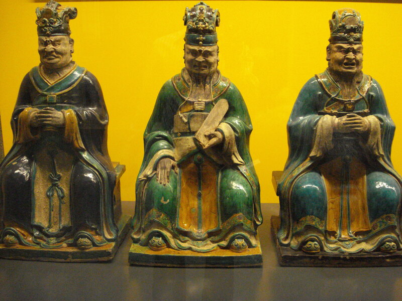 Three ceramic statues in museum