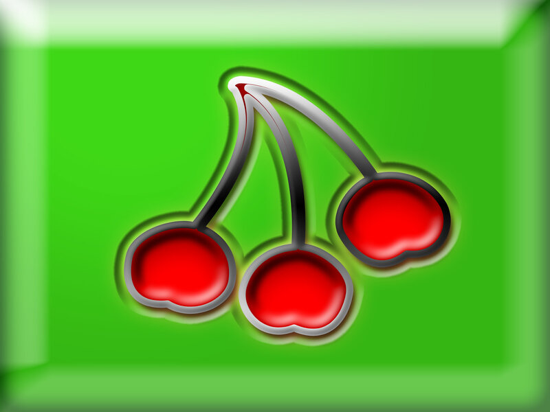 three cherries on green background