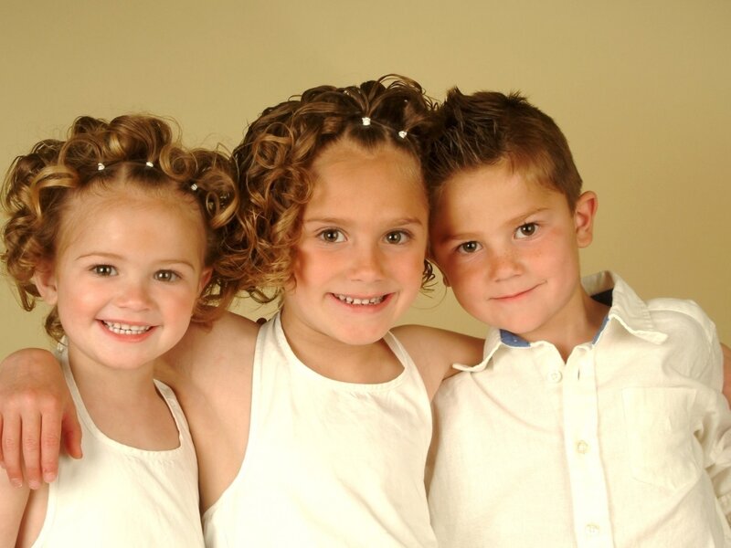 Three Children Hugging — White