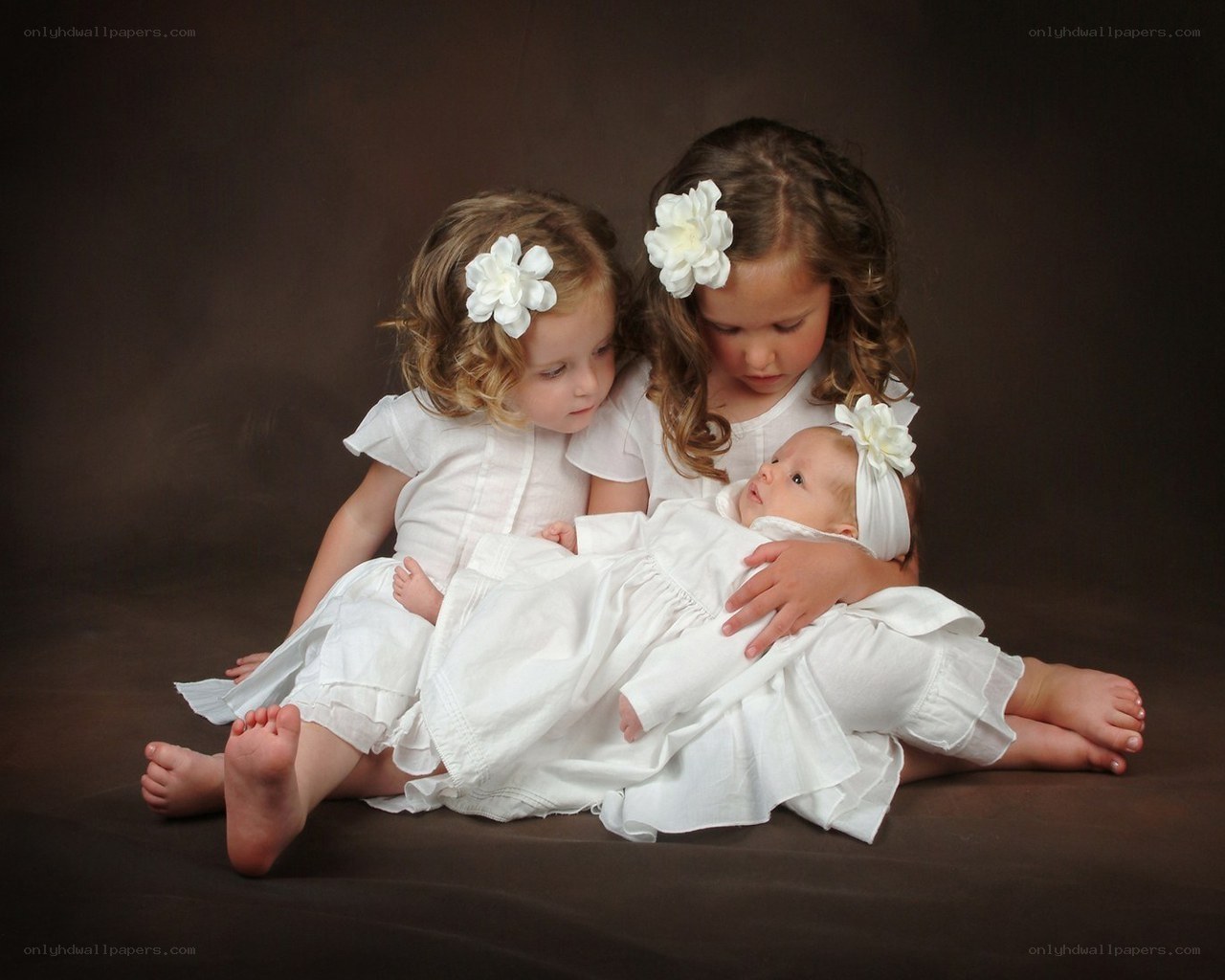 three children in white dresses