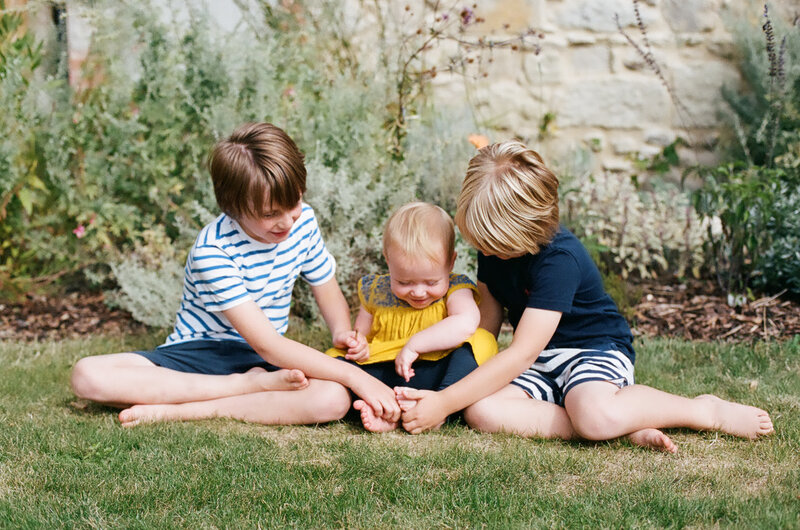 Three Children on Grass — Green, Calm