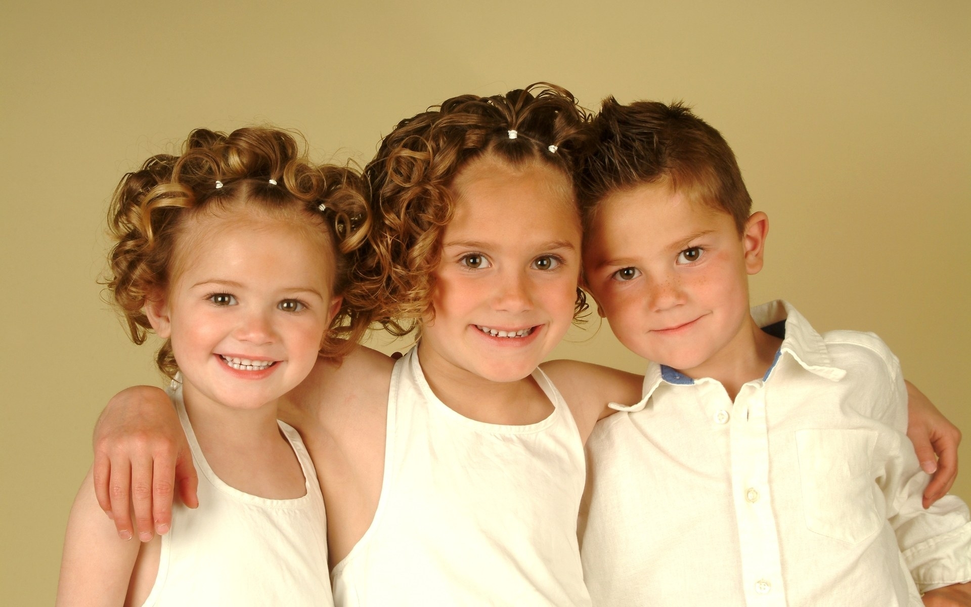 three children posing together