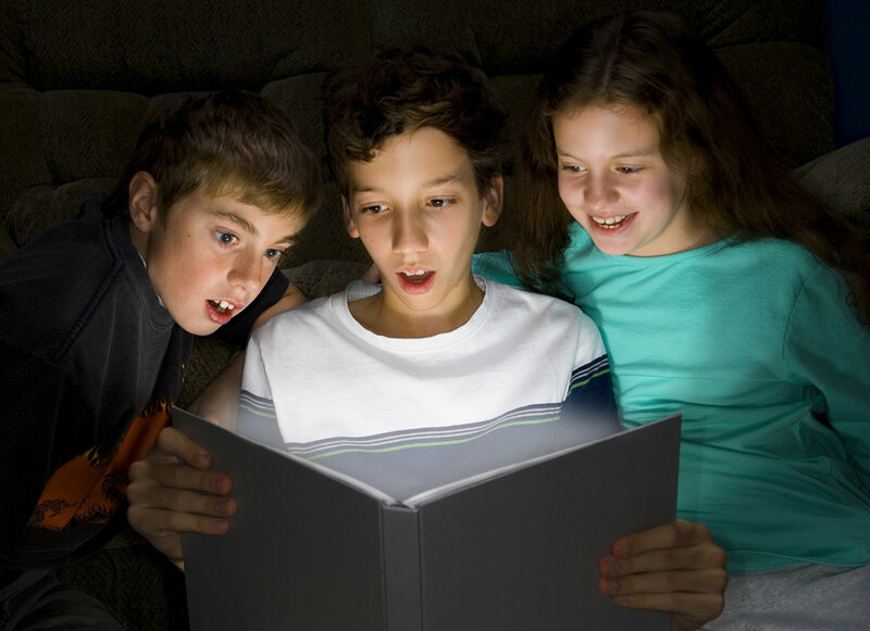 Three Children Reading Book