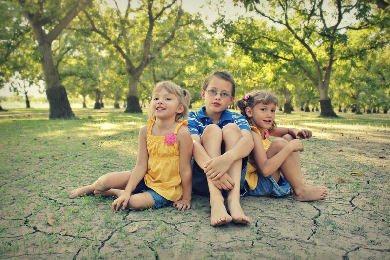 Three Children Sitting — Green, Serene