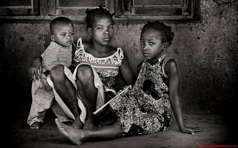 three children sitting on ground