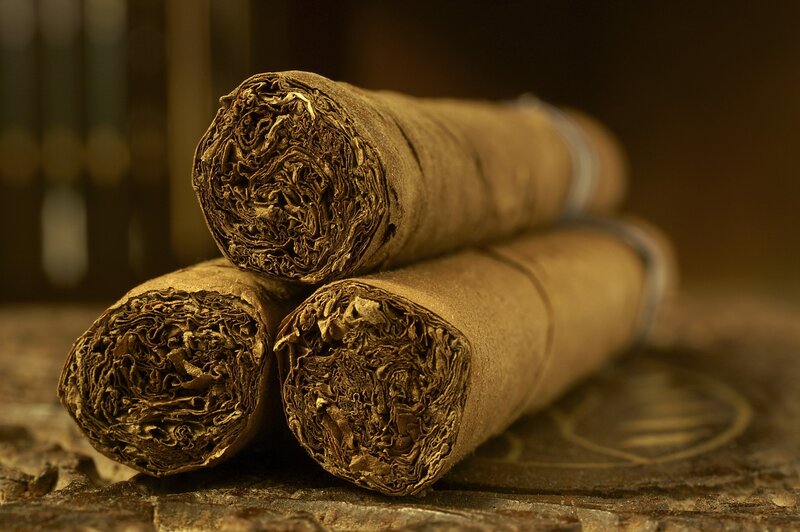 Three Cigars on Wood