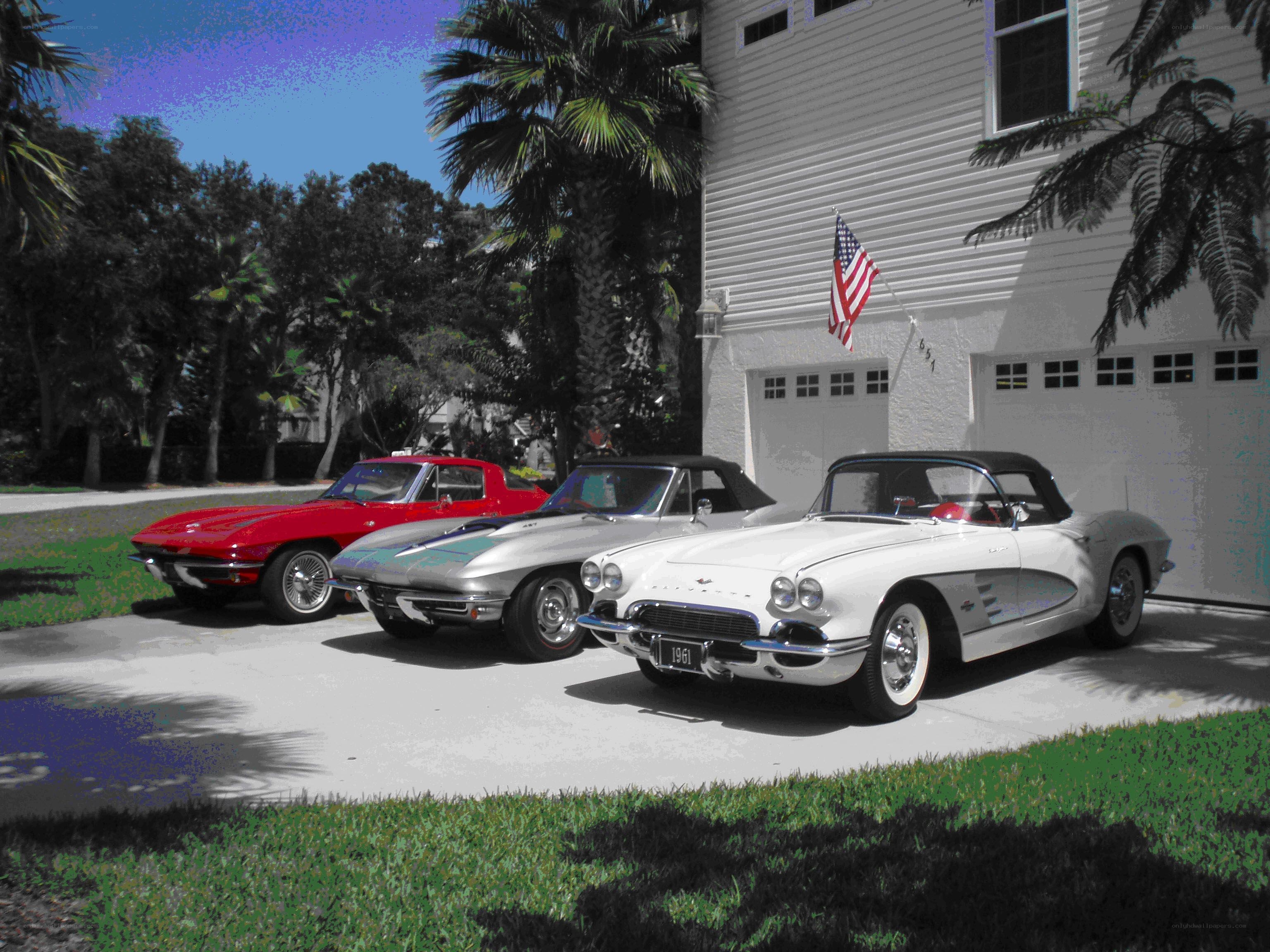 Three classic Corvettes in driveway