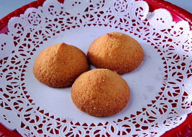 three coconut cookies on a doily
