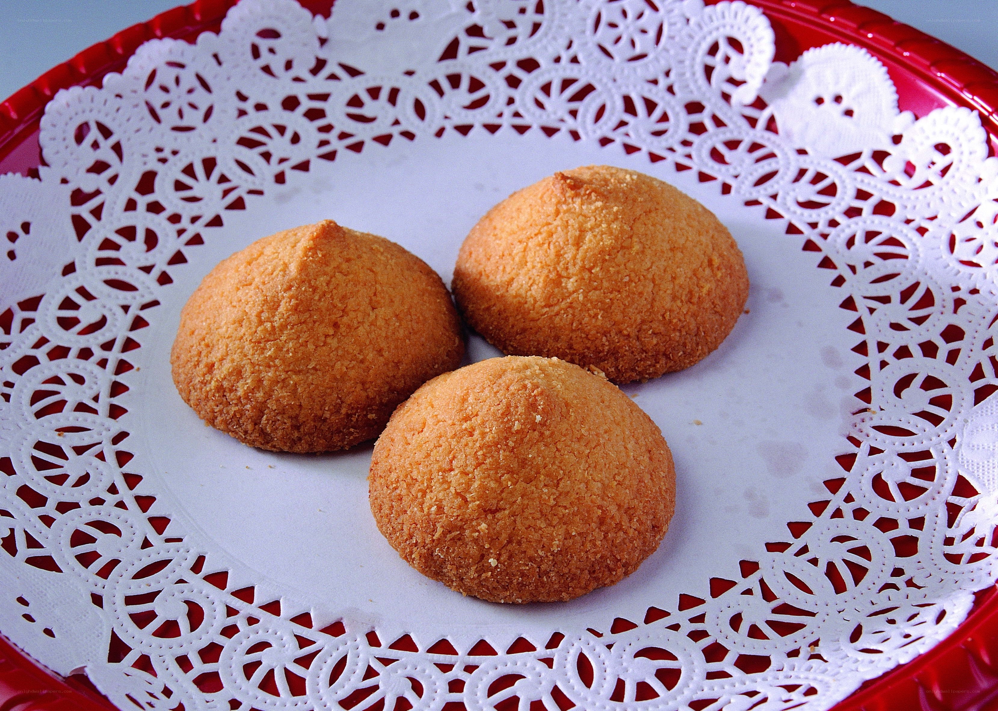 three coconut cookies on a doily