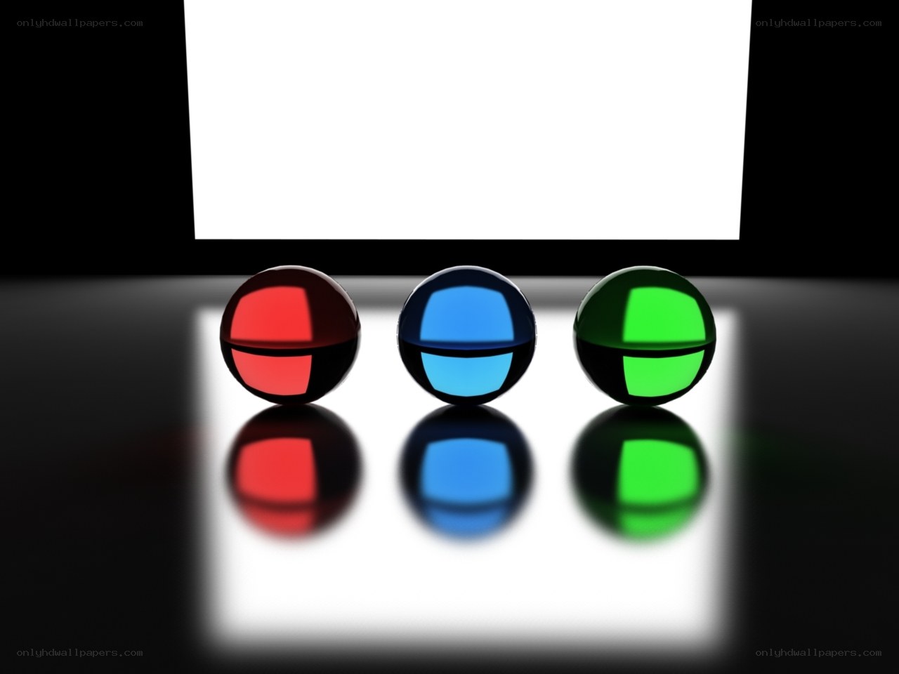 Three colored spheres on reflective surface