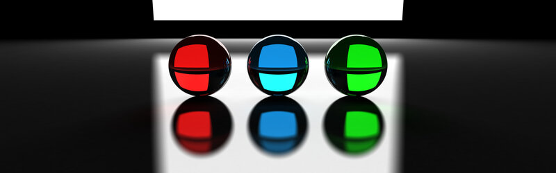 three colored spheres on reflective surface