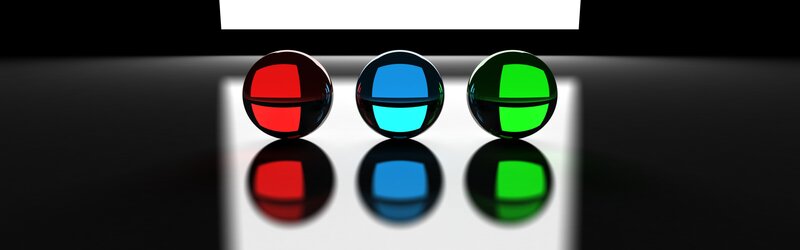 Three colored spheres on reflective surface