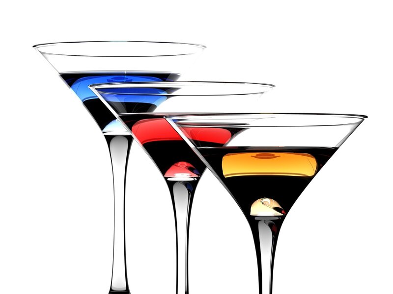 Three colorful cocktails in martini glasses