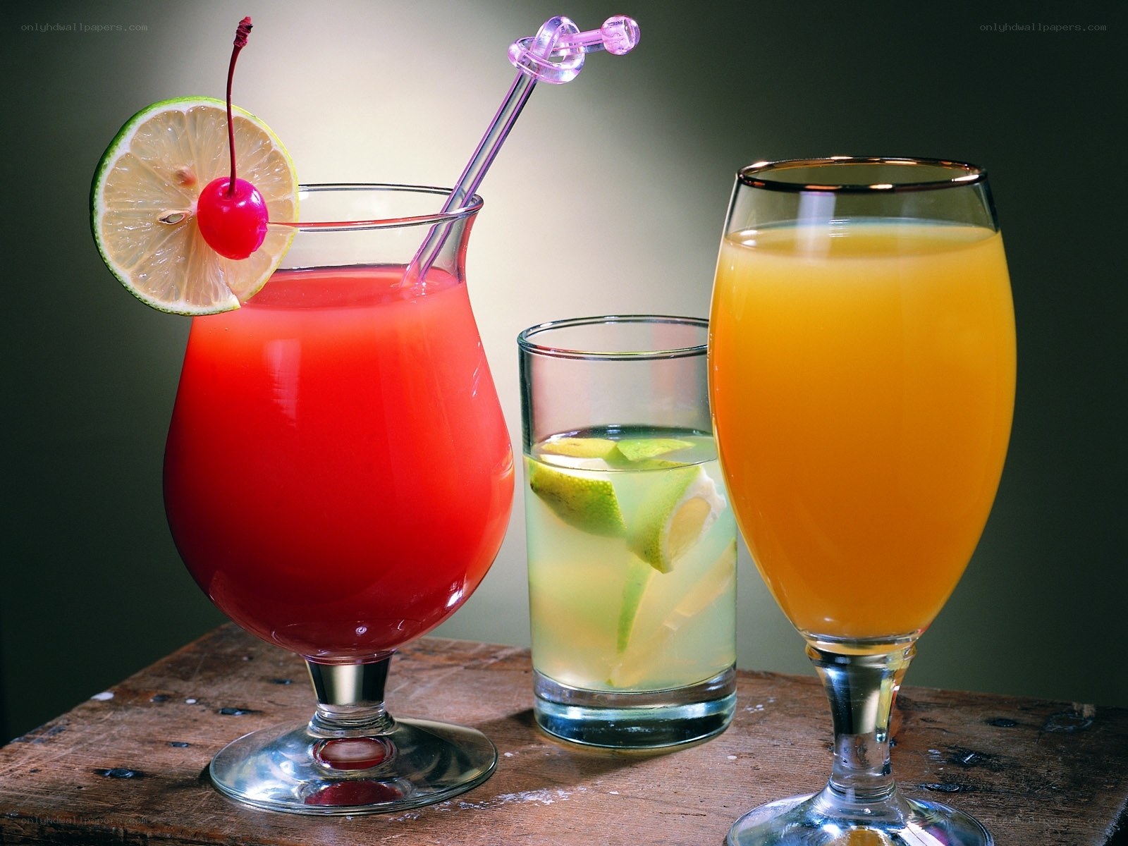 Three colorful cocktails on wood