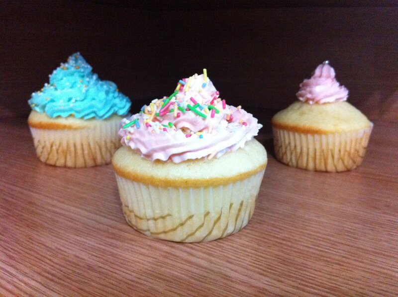 Three colorful cupcakes on a table