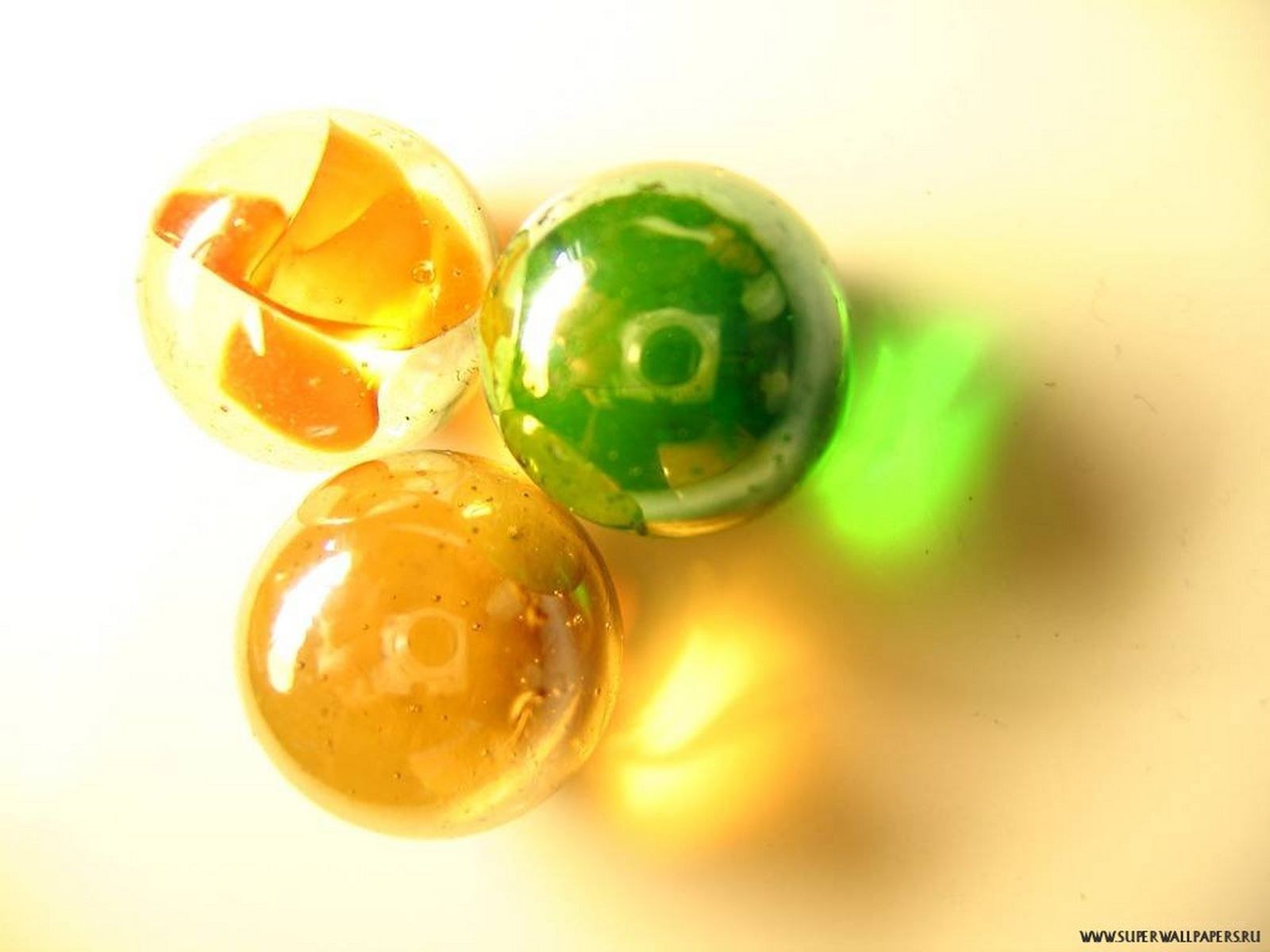 three colorful glass marbles